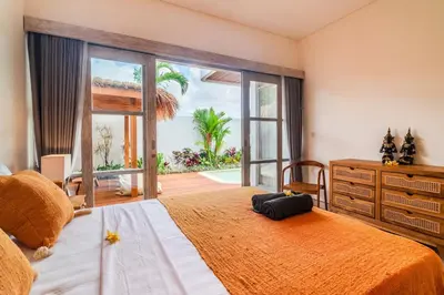 a bedroom with a large bed and a large window at NEW Villa Chim Chim Modern 2BR Tropical with Pool in Seminyak