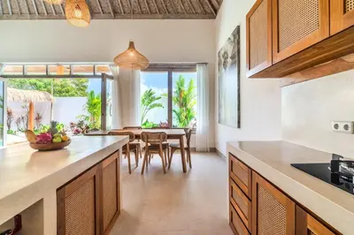 a kitchen and dining room with a table and chairs at NEW Villa Chim Chim Modern 2BR Tropical with Pool in Seminyak