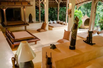 a living room with a couch and a table at Nomadic Resort Bali in Canggu