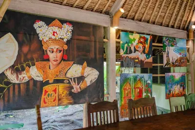 a room with a painting of a woman on the wall at Nomadic Resort Bali in Canggu