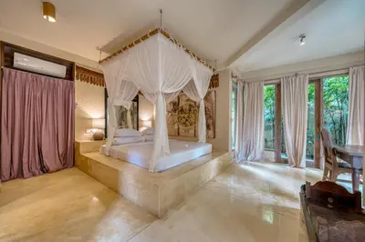 a bedroom with a bed with a canopy at Nomadic Resort Bali in Canggu