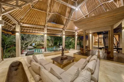 a large living room with a couch and a table at Nomadic Resort Bali in Canggu