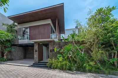 an external view of a house with trees at Akar & Daun - NEW! 8BR Villa Haven, Near Berawa Beach! in Canggu