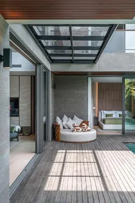 a room with a bed on a patio at Akar & Daun - NEW! 8BR Villa Haven, Near Berawa Beach! in Canggu