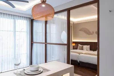 a living room with a large window and a bed at Baliris Home Boutique Legian in Seminyak