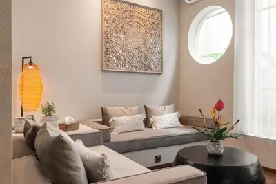 a living room with a couch and a table at Baliris Home Boutique Legian in Seminyak