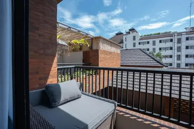 a pillow sitting on a balcony with a building at Baliris Home Boutique Legian in Seminyak
