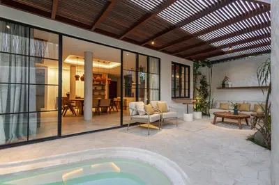 a house with a swimming pool and a patio at Nila Villa Berawa Canggu in Canggu
