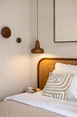 a bedroom with a bed and two pendant lights at Nila Villa Berawa Canggu in Canggu