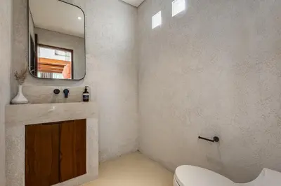 a bathroom with a sink and a mirror at Nila Villa Berawa Canggu in Canggu