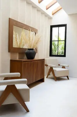 a living room with two chairs and a mirror at Nila Villa Berawa Canggu in Canggu