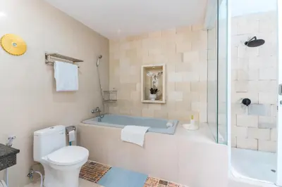 a bathroom with a tub and a toilet and a shower at Seminyak Luxe Villa Near Beach, Breakfast Concierge in Seminyak