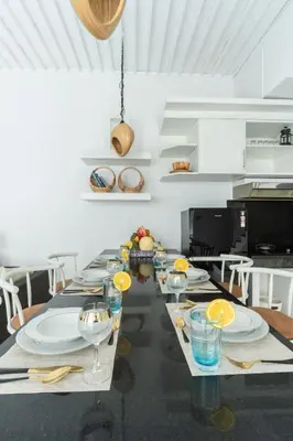 a long table with plates and glasses on it at Seminyak Luxe Villa Near Beach, Breakfast Concierge in Seminyak