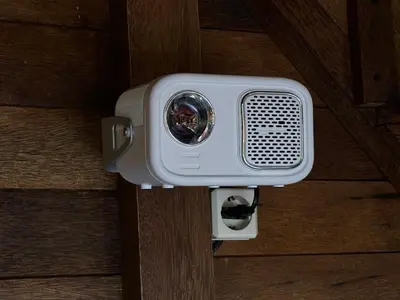 a security camera is attached to a wooden door at Cozy Lagoon Bungalows & Pool in Nusa Dua