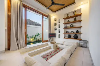a living room with a white couch and a large window at 2BR Private tropical villas in Jimbaran in Jimbaran