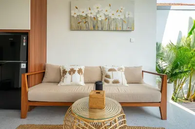 a living room with a couch and a table at Modern 2BR Umalas Villa with Private Pool & Garden in Kerobokan