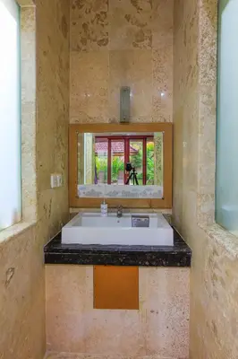 a bathroom with a white sink and a window at 1 Bed Room Villa in Kuta Central in Kuta