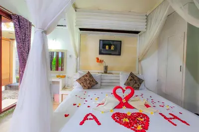 a bedroom with a bed with a heart on it at 1 Bed Room Villa in Kuta Central in Kuta