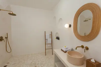 a bathroom with a sink and a mirror at Adhya Villa by GenuineHost in Kerobokan