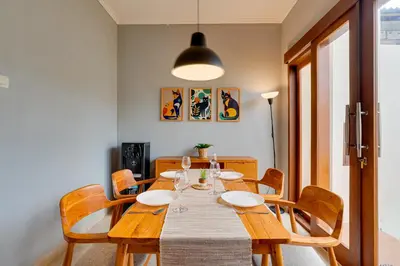 a dining room with a wooden table and chairs at Cozy 2BR Villa Taman Seminyak Suite 05 in Seminyak Bali in Seminyak