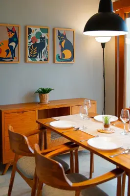 a dining room with a table and chairs with wine glasses at Cozy 2BR Villa Taman Seminyak Suite 05 in Seminyak Bali in Seminyak