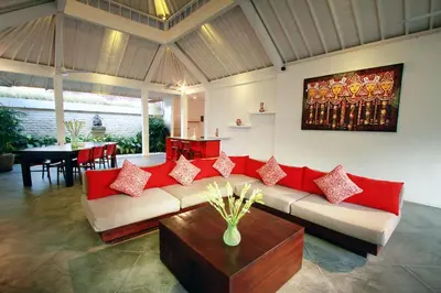 a living room with a couch and a table at Villa Alma in Legian