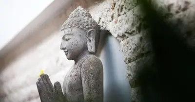 a statue of a person holding a flower at Villa Alma in Legian
