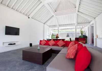 a living room with a couch and red pillows at Villa Alma in Legian