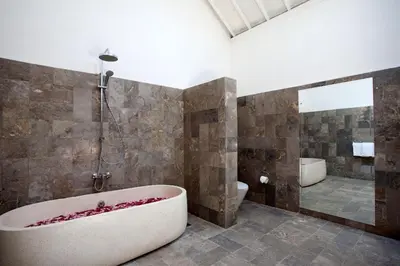 a bathroom with a bath tub and a shower at Villa Alma in Legian