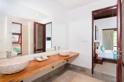 a bathroom with a large sink and a large mirror at Villa Amalia Walk To Legian Beach in Legian