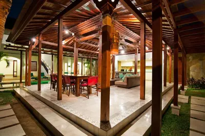 a wooden pavilion with a table and chairs at Villa Amalia Walk To Legian Beach in Legian
