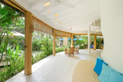 an outdoor patio with chairs and a ceiling at Mosaic Villa Sanur in Sanur