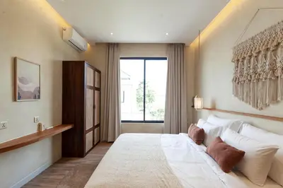 a bedroom with a large bed and a window at Casa Amani 3BR Terracotta Seminyak in Kerobokan