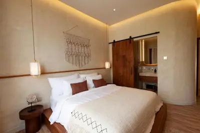 a bedroom with a large white bed in a room at Casa Amani 3BR Terracotta Seminyak in Kerobokan