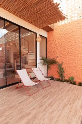 two white chairs sitting on a wooden deck at Casa Amani 3BR Terracotta Seminyak in Kerobokan