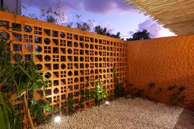 a brick wall with a christmas tree on it at Casa Amani 3BR Terracotta Seminyak in Kerobokan