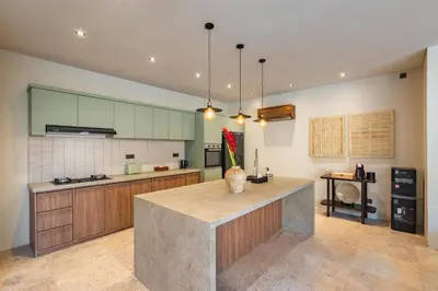 a large kitchen with a island in the middle at Konoha Villa Umalas in Mantaak