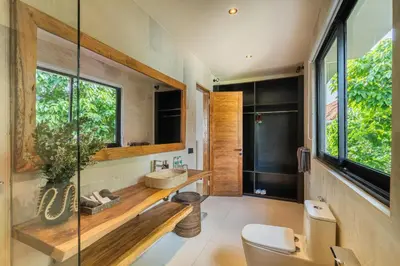 a bathroom with a sink and a glass shower at Konoha Villa Umalas in Mantaak