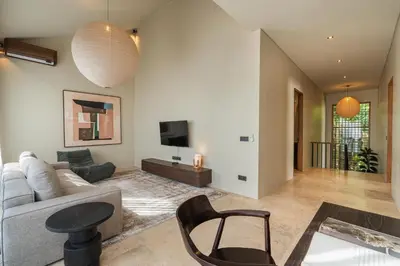 a living room with a couch and a tv at Konoha Villa Umalas in Mantaak