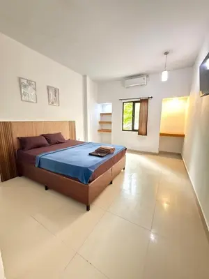 a bedroom with a large bed in a room at OKIE HOUSE HOTEL Poppies2 3 min from Kutabeach in Legian