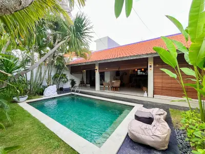 a swimming pool in the yard of a house at Villa Sayang 1 Seminyak in Seminyak
