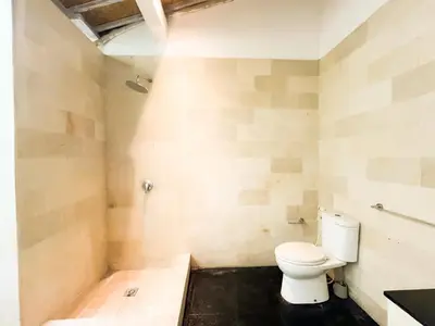 a bathroom with a white toilet in a room at Villa Sayang 1 Seminyak in Seminyak