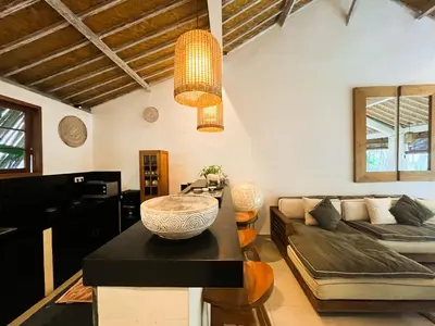 a living room with a couch and a table at Villa Sayang 1 Seminyak in Seminyak