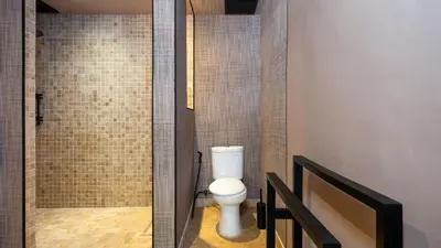 a bathroom with a toilet and a walk in shower at Villa Dreamora by Villa Finder in Seminyak