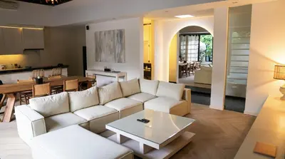 a living room with a white couch and a table at Villa Nata Umalas in Seminyak