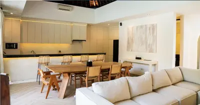 a living room with a table and a couch at Villa Nata Umalas in Seminyak