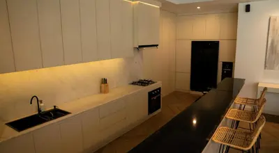 a kitchen with a sink and a stove top oven at Villa Nata Umalas in Seminyak