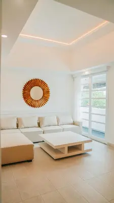 a living room with a couch and a mirror at Apartment Nata Umalas in Seminyak