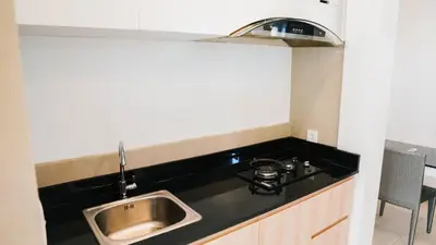 a kitchen with a sink and a stove at Apartment Nata Umalas in Seminyak
