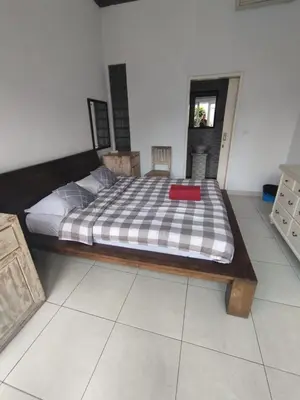 a bedroom with a bed with a red box on it at sari uma in Seminyak